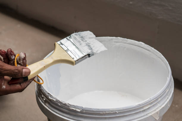 istock Paint brush and white color paint bucket 1030458574
