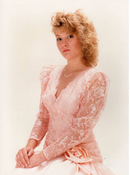 Teenage blond girl in pink dress stock photo