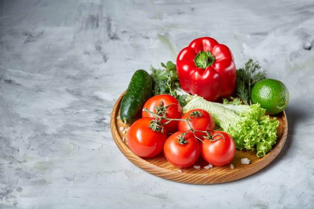 istock Delicious composition of assorted fresh vegetables and herbs on white textured background, top view, selective focus. 1030462444