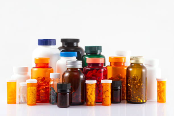 Pill Bottles Close-up shot of colorful pill bottles pharma herbal medicine pill medicine stock pictures, royalty-free photos & images