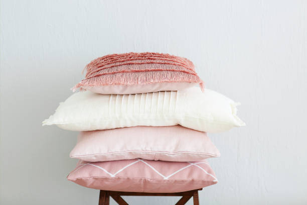 istock Pink and white pillows on the wall background 1030474704