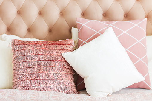 Modern bedroom with pink pillows. Close up
