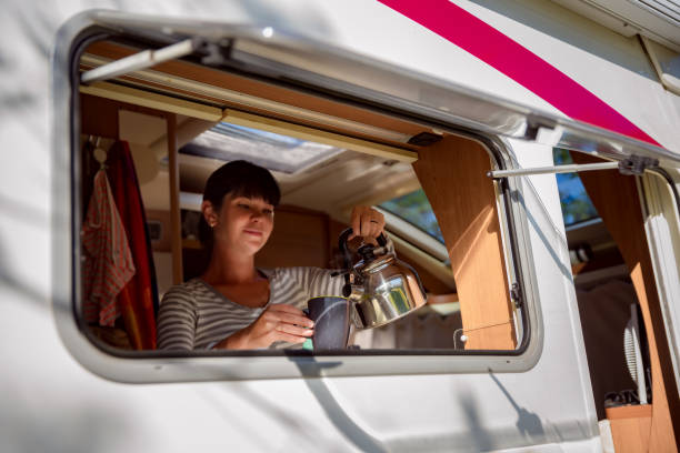 istock Woman cooking in camper, motorhome interior 1030477652