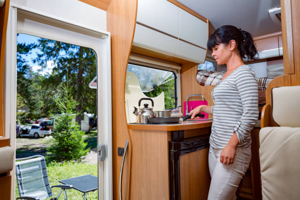 istock Woman cooking in camper, motorhome RV interior 1030477708
