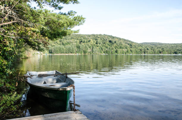 istock Row boat at the pier on a lake during summer day 1030485008