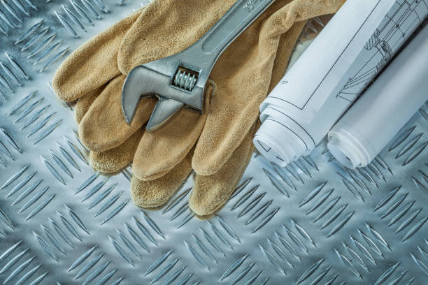 istock Blueprints adjustable spanner safety gloves on channeled metal s 1030486636
