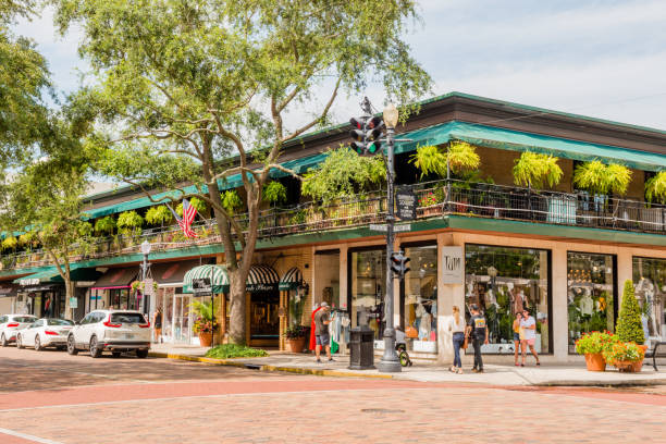 Park Avenue in Downtown Winter Park Florida USA This is a horizontal, color photograph Park Avenue in downtown Winter Park, Florida. People walk outside along the sidewalk. winter park florida stock pictures, royalty-free photos & images
