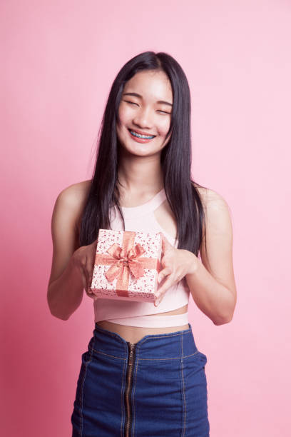 istock Young Asian woman with a gift box. 1030491922