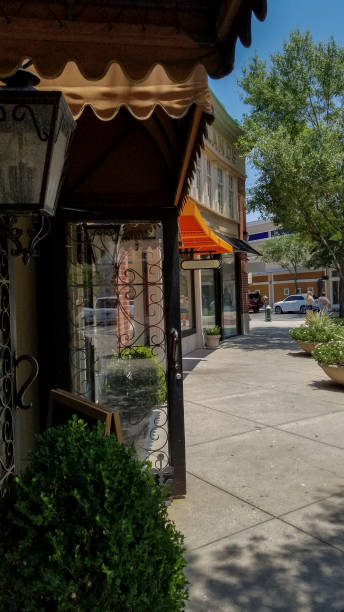 istock City sidewalk with shops at side. 1030503074