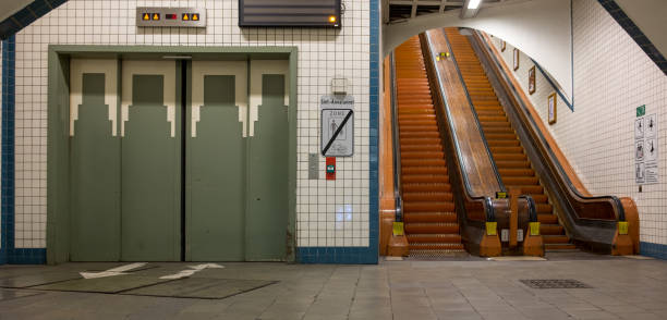 Lift and wooden escalators in the Sint-Anna Pedestrian Tunnel Lift and wooden escalators in the Sint-Anna Pedestrian Tunnel, Tuesday 13 June 2017, Antwerp, Belgium. linker stock pictures, royalty-free photos & images