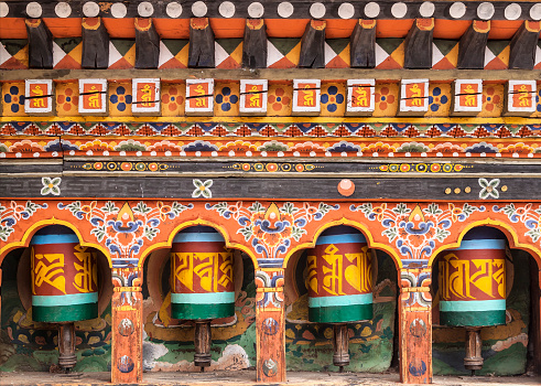 Turning prayer wheels mantra in Bhutan with traditional writing mantra which sounds as 