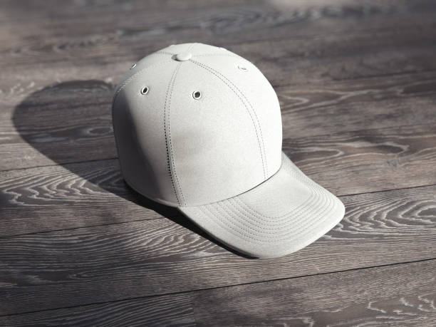 istock Close up of white cap isolated on wooden background, 3d rendering 1030509940