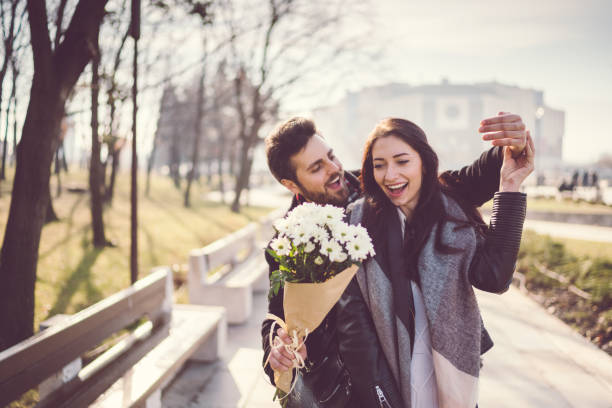 Couple dating on Valentine's day Young people dating in the city man flower stock pictures, royalty-free photos & images