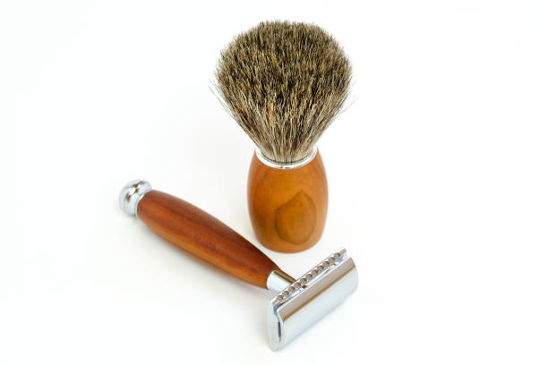 istock Traditional razor with hairy shaving brush isolated in white 1030515376