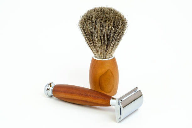 istock Traditional razor with hairy shaving brush isolated in white 1030515400