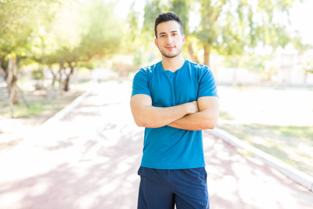 istock Young Man Standing Arms Crossed Before Workout In Park 1030518384