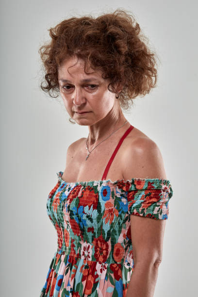 istock Sad mture woman isolated on gray 1030522124