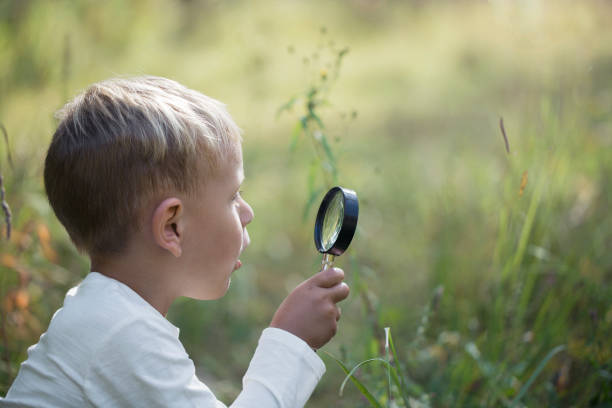 istock A small boy explores with a magnifying glass 1030530008