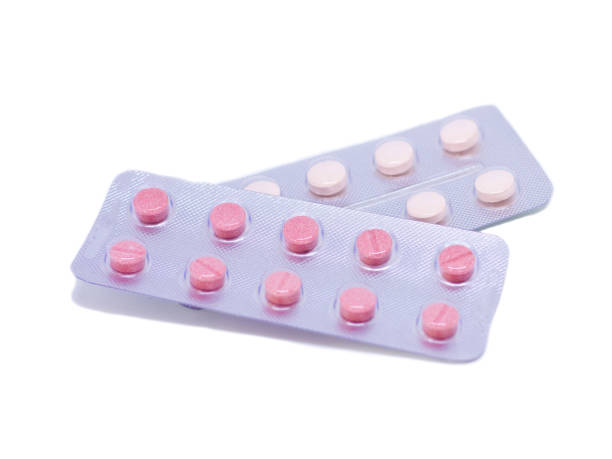 istock Pink pills in a package isolated on a white background 1030533588