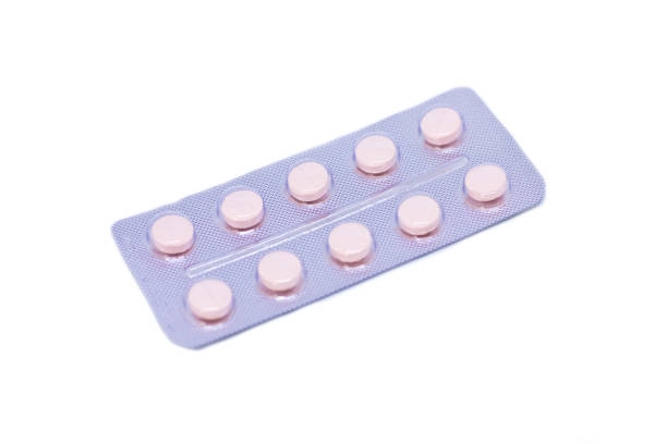 istock Pink pills in a package isolated on a white background 1030533972