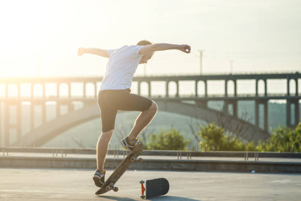 istock Skateboarder doing a trick in a jump at sunset. 1030542518