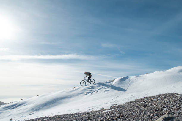 snow biking snow cyclist is training hard and fast stock pictures, royalty-free photos & images
