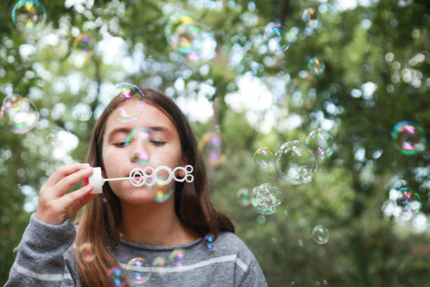 istock Girl and Soap Bubbles 1030554320