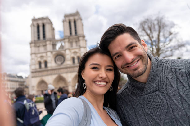 istock Happy couple sightseeing in Paris and taking a selfie 1030562524