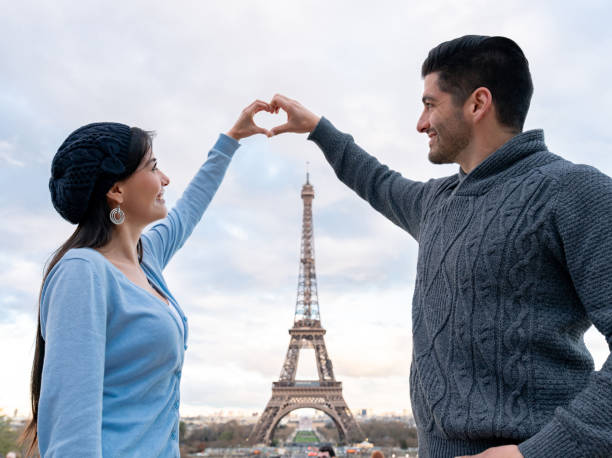 istock Loving couple on a romantic getaway in Paris making a heart shape 1030562702