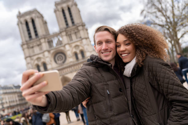 istock Happy couple sightseeing in Paris and taking a selfie 1030562796