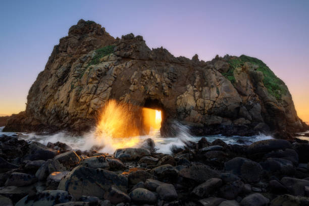 istock Sunset through key hole Pfeiffer beach, California 1030563240