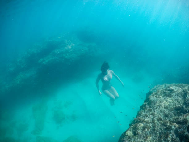 istock Woman underwater in tropical sea 1030568114