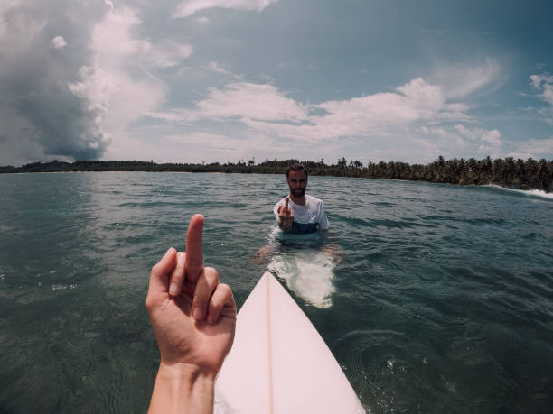 istock Two surfers showing each other the finger 1030570472