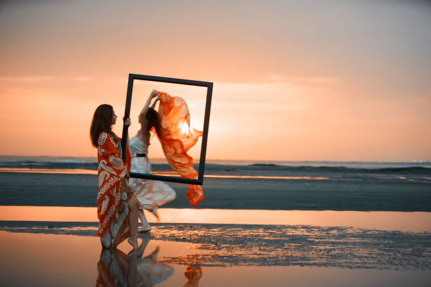 istock Portrait of a Two Young women holding an empty frame 1030580500