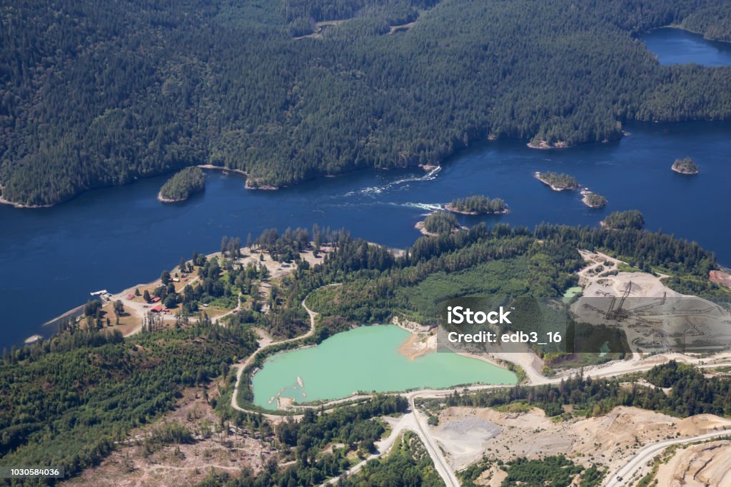Sunshine Coast Aerial Aerial view of mining industry near Sechelt Inlet during a vibrant sunny day. Located in Sunshine Coast, BC, Canada. Mining - Natural Resources Stock Photo