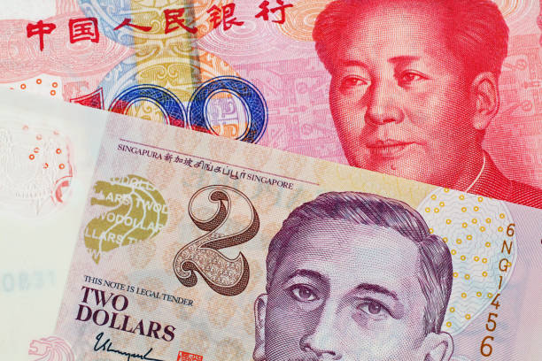istock A two Singapore Dollar bank note with a hundred Chinese Yuan banknote 1030584308