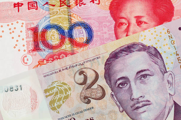 istock A two Singapore Dollar bank note with a hundred Chinese Yuan banknote 1030584518