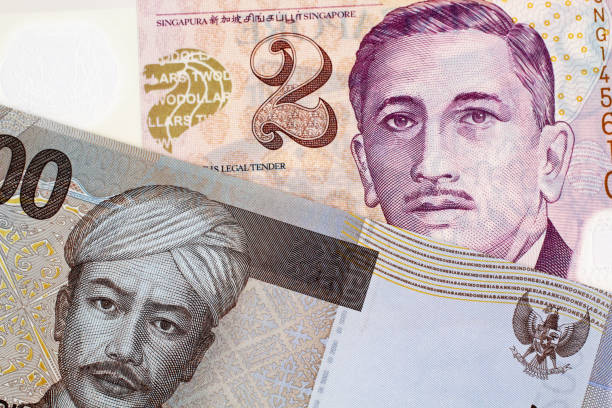 istock An Indonesian 2000 Rupiah bank note with a Two Singapore Dollar Bank Note 1030584520