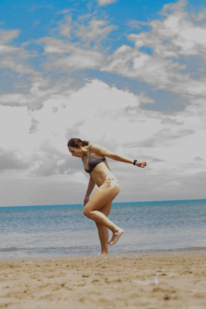 istock Female Model on the Beach Looking Out on the Ocean 1030591458
