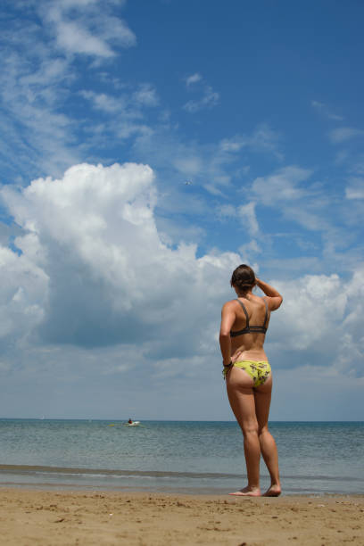 Female Model on the Beach Looking Out on the Ocean