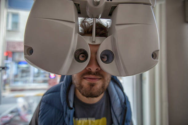 istock man's face behind ophthalmology equipment 1030594000