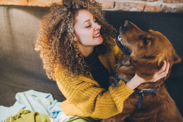 istock Woman playing with her dogs 1030594400