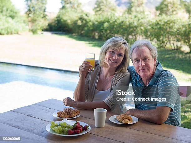 Foto de Casal Tomando Café Da Manhã No Jardim e mais fotos de stock de 55-59 anos - 55-59 anos, 60-64 anos, Adulto