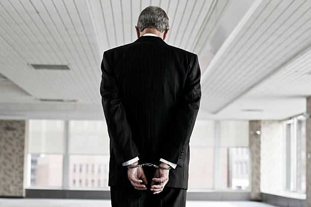 Businessman in handcuffs  criminal stock pictures, royalty-free photos & images
