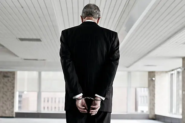 Photo of Businessman in handcuffs