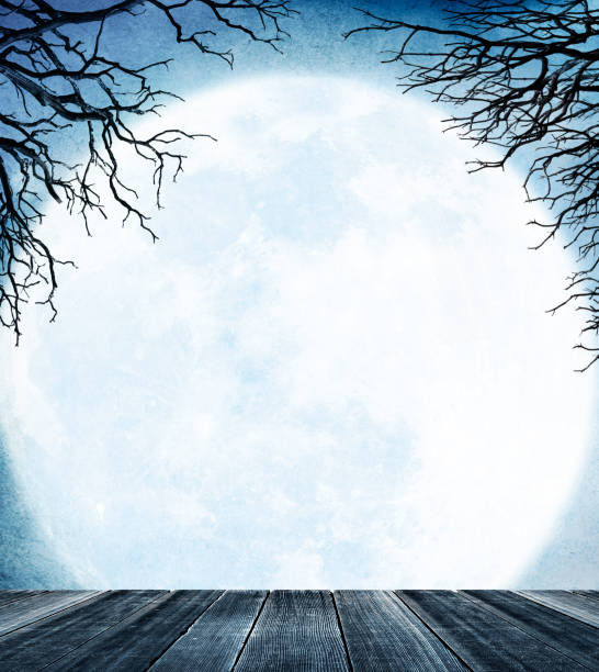 istock Large Moon Rises Over Wooden Porch Framed By Bare Trees 1030618620