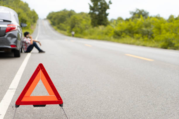 istock A car breakdown alongside the road.
Driver calling for emergency help.  broken car on the road.
man having car trouble on the country road, putting traffic warning triangle sign on asphalt road. Emergency stop concept. 1030621102