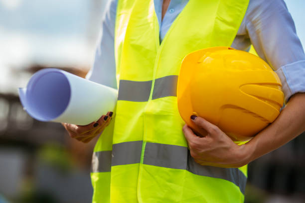 istock Close-up of architect holding blueprints and hardhat 1030624012