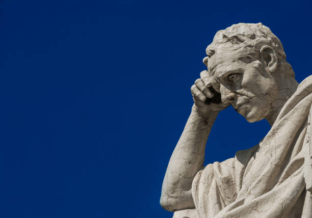 Thinking Man statue (with copy space) Man statue in the act of thinking against blue sky. Ancient Roman Julian the Jurist statue erected at the end of 19th century in front of the Old Palace of Justice in Rome philosophy stock pictures, royalty-free photos & images