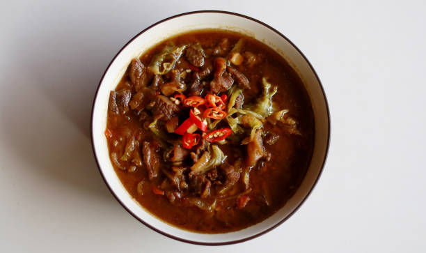 Tongseng of Goat Meat Tongseng. Goat meat stew cooked with sweet soy sauce, coconut milk, shredded cabbage and tomatoes. Commonly found in Indonesian region of Central Java, from Surakarta to Yogyakarta. central java province photos stock pictures, royalty-free photos & images